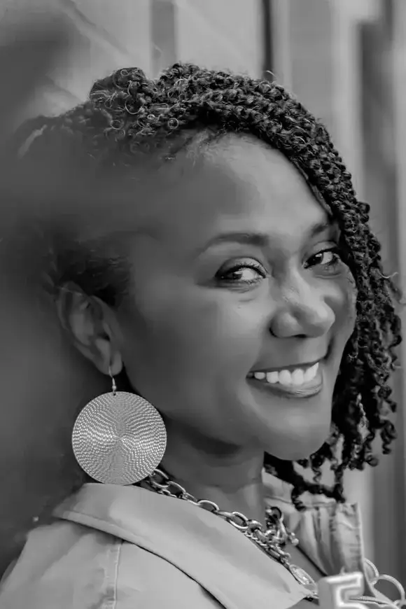 Dawn positioned to receive...standing next to wall holding a cuocake in celebration of 5 years og DND365