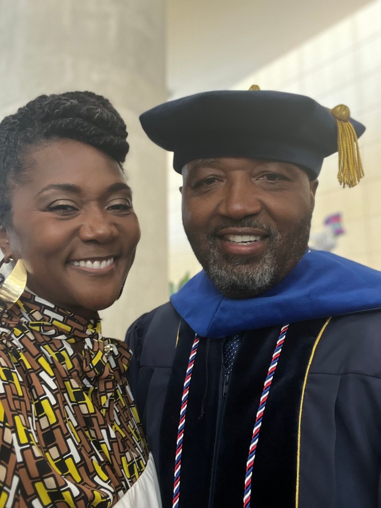 Leon Green in his doctorate regalia, with Dawn by his side. 